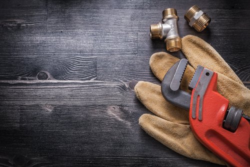 Monkey,Wrench,Brass,Plumbing,Fittings,Leather,Safety,Gloves,Construction,Concept.